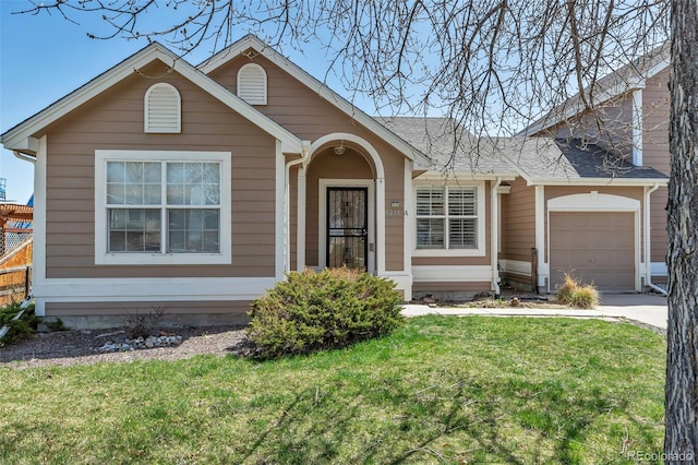 view of front of house featuring a garage and a front lawn