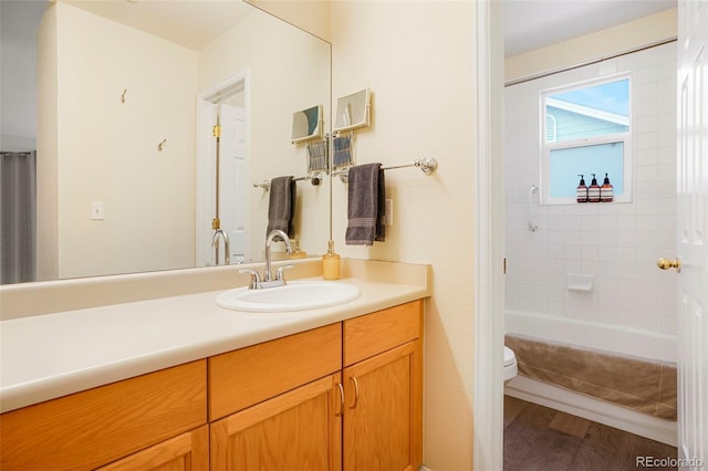 full bathroom with shower / bath combo, hardwood / wood-style floors, toilet, and vanity