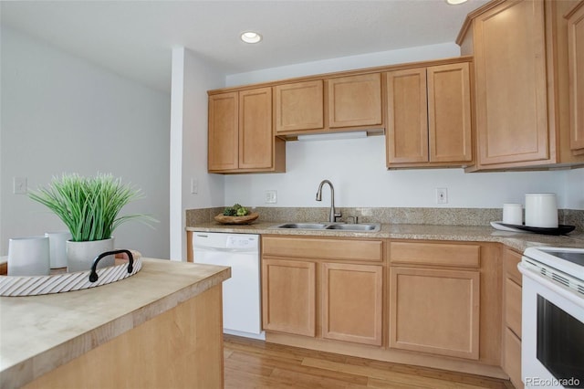 kitchen with light wood-type flooring, a sink, recessed lighting, white appliances, and light countertops