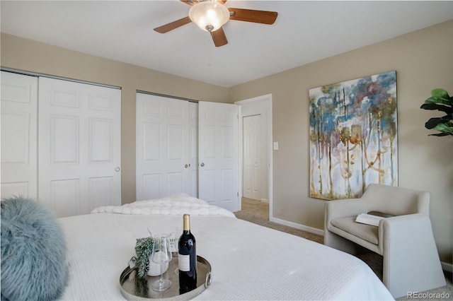 carpeted bedroom featuring ceiling fan, baseboards, and multiple closets