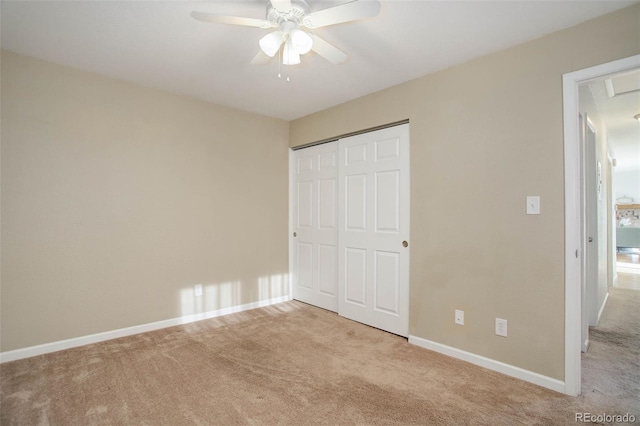 unfurnished bedroom featuring a closet, baseboards, a ceiling fan, and carpet flooring