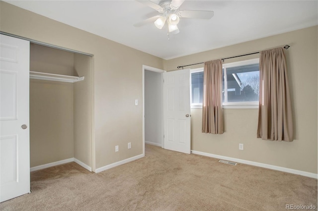 unfurnished bedroom featuring a closet, visible vents, baseboards, and carpet