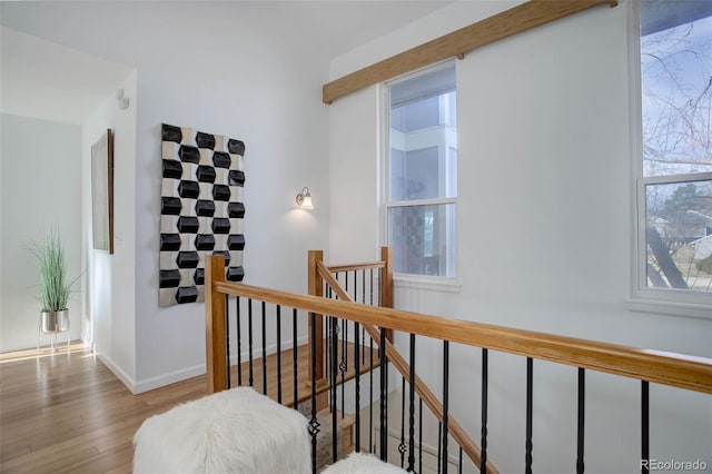 stairway with baseboards and wood finished floors