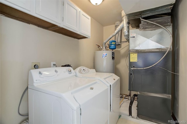 clothes washing area with heating unit, cabinet space, washing machine and dryer, and water heater