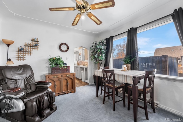 carpeted dining area featuring ceiling fan