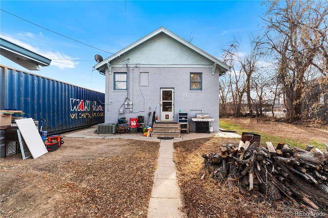 rear view of house with central AC unit