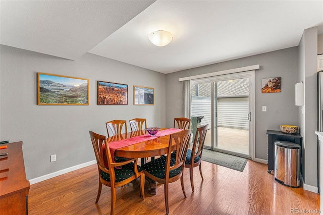 dining area with light hardwood / wood-style floors