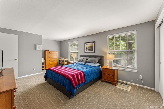 carpeted bedroom featuring multiple windows