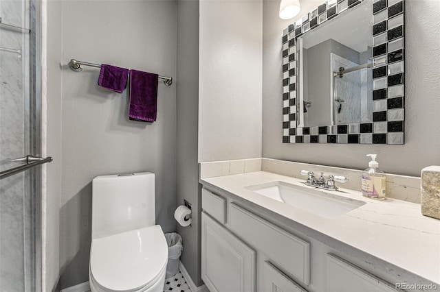 bathroom featuring tile patterned floors, walk in shower, vanity, and toilet