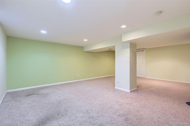 finished below grade area with baseboards, carpet, and recessed lighting