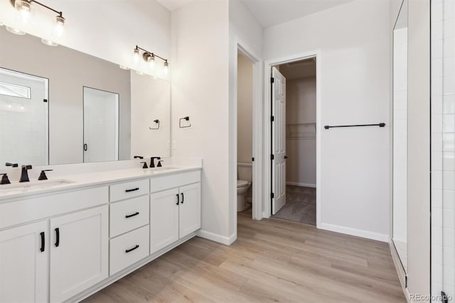 bathroom with vanity, hardwood / wood-style flooring, and toilet