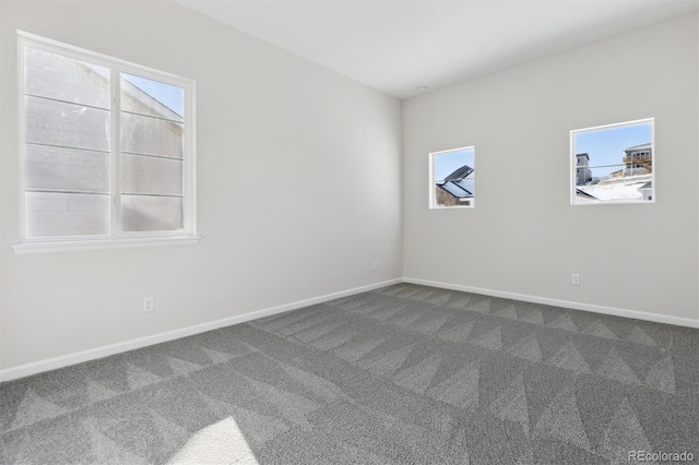 unfurnished room featuring carpet