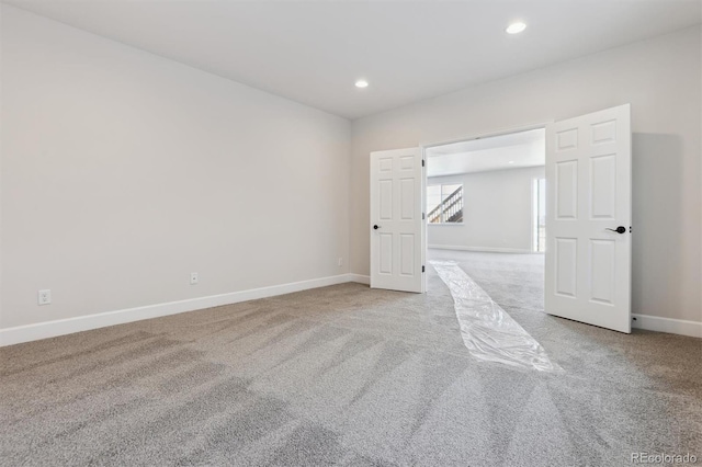 spare room featuring light colored carpet