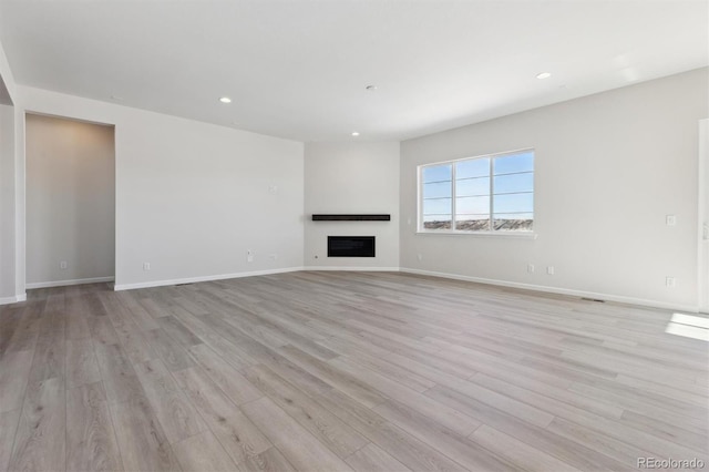 unfurnished living room with light wood-type flooring