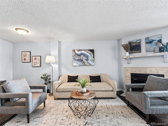 living room featuring a fireplace and a textured ceiling