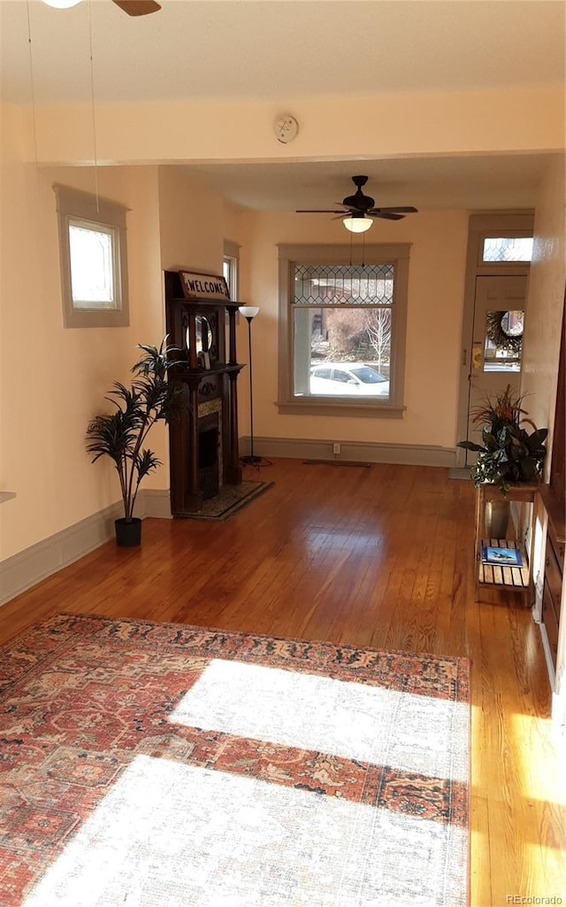 entryway with wood-type flooring and ceiling fan