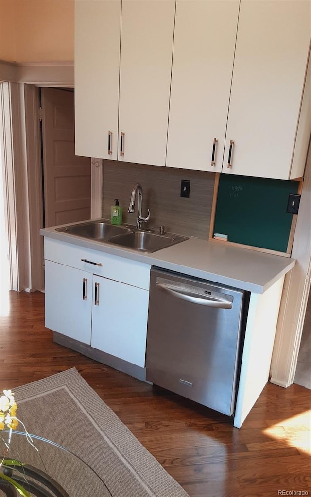 kitchen with white cabinetry, dishwasher, sink, backsplash, and dark wood-type flooring