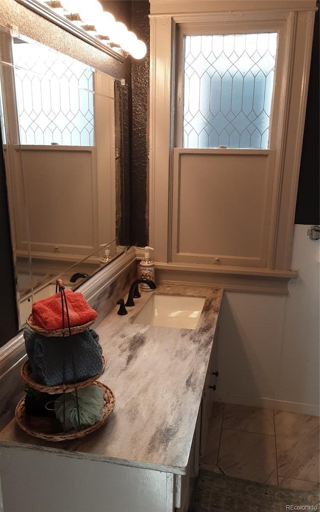 bathroom featuring a healthy amount of sunlight and vanity