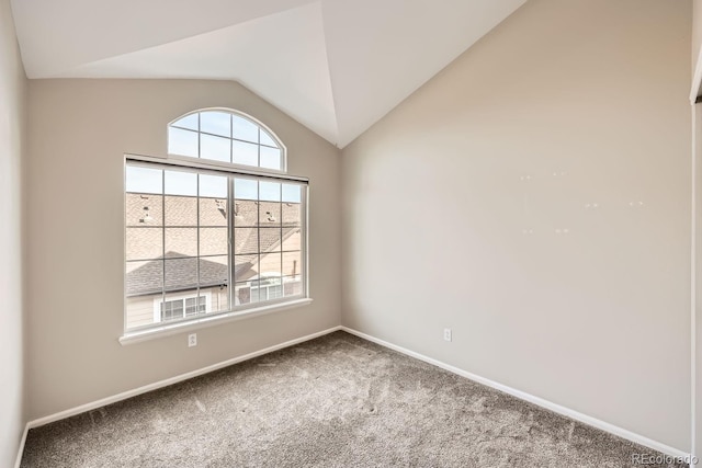 carpeted empty room with lofted ceiling