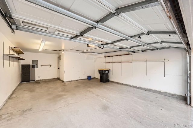 garage with electric panel and a garage door opener