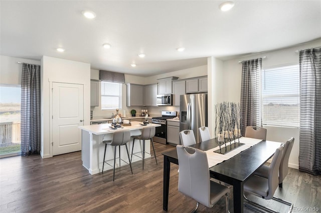 11782 Foraker Ln, Colorado Springs, CO 80925 - dining space featuring dark wood-style flooring and recessed lighting