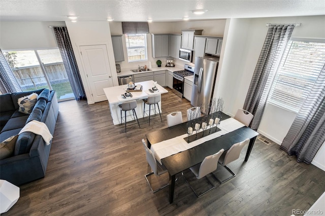 11782 Foraker Ln, Colorado Springs, CO 80925 - dining room with dark wood finished floors and a textured ceiling