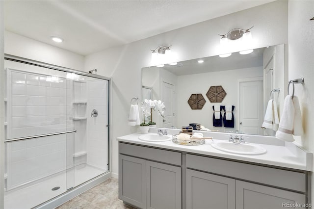 11782 Foraker Ln, Colorado Springs, CO 80925 - bathroom featuring a shower stall, double vanity, and recessed lighting