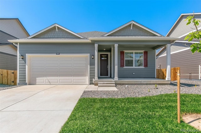 13487 Valentia St, Thornton, CO 80602 - view of front of home with covered porch, concrete driveway, and a garage