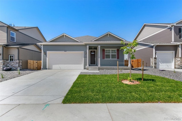 13487 Valentia St, Thornton, CO 80602 - view of front of home featuring a garage, covered porch, and driveway