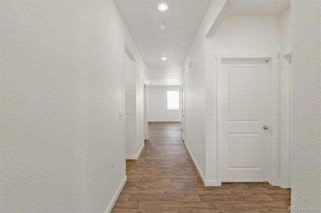 13487 Valentia St, Thornton, CO 80602 - hallway with wood finished floors, baseboards, and recessed lighting