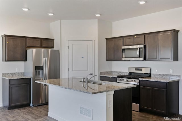 13487 Valentia St, Thornton, CO 80602 - kitchen featuring stainless steel appliances, a sink, dark wood-type flooring, dark brown cabinetry, and recessed lighting