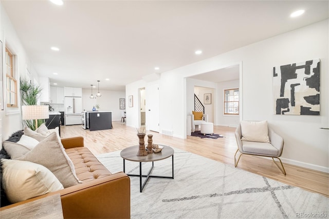 living room with light hardwood / wood-style flooring