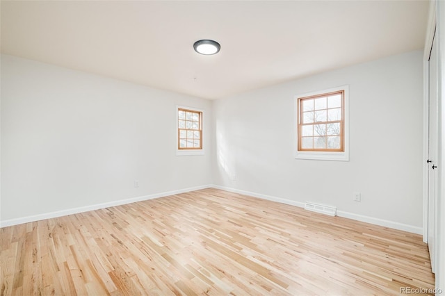 unfurnished room with light hardwood / wood-style floors