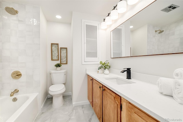 full bathroom featuring vanity, tiled shower / bath combo, and toilet