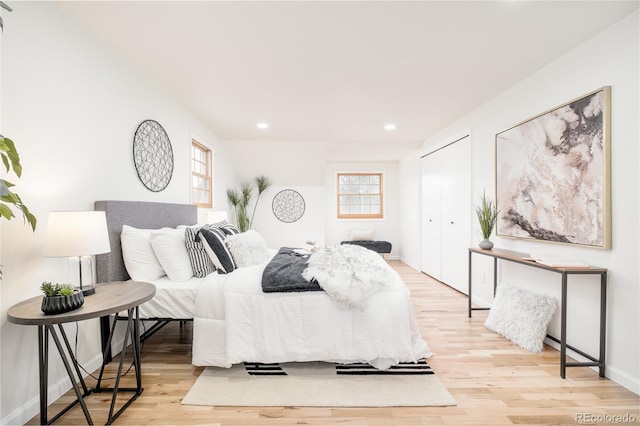 bedroom featuring light hardwood / wood-style floors and a closet