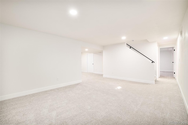 basement featuring light carpet