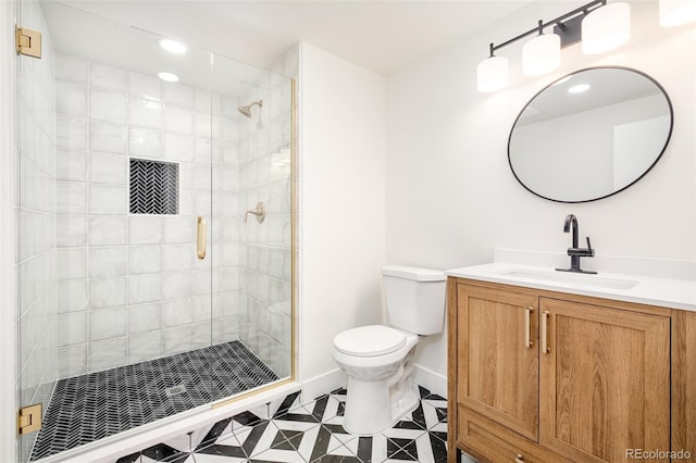 bathroom featuring vanity, toilet, and an enclosed shower