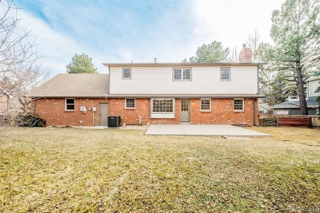 rear view of property with central AC unit, a lawn, and a patio