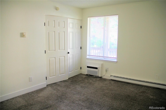 14780 E Kentucky Dr Unit 414, Aurora, CO 80012 - unfurnished bedroom featuring a baseboard radiator, dark colored carpet, and a wall mounted air conditioner