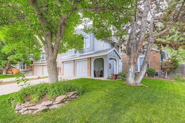 10360 Irving Ct, Westminster, CO 80031 - view of front of house featuring board and batten siding, an attached garage, brick siding, and driveway