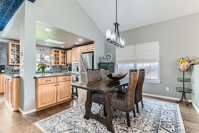 10360 Irving Ct, Westminster, CO 80031 - dining area featuring wood finished floors, recessed lighting, lofted ceiling, and a chandelier