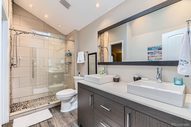 10360 Irving Ct, Westminster, CO 80031 - bathroom with vaulted ceiling, a shower stall, vanity, wood finished floors, and recessed lighting