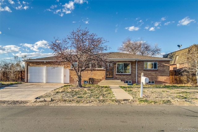 6095 W 47th Ave, Wheat Ridge, CO 80033 - single story home with brick siding, an attached garage, concrete driveway, and fence