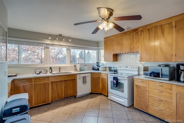 6095 W 47th Ave, Wheat Ridge, CO 80033 - kitchen with white appliances, a sink, light countertops, a ceiling fan, and backsplash