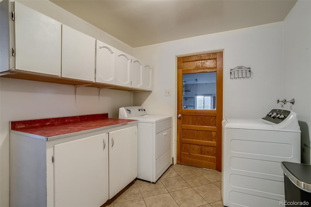 6095 W 47th Ave, Wheat Ridge, CO 80033 - laundry area with cabinet space, washing machine and clothes dryer, and light tile patterned floors