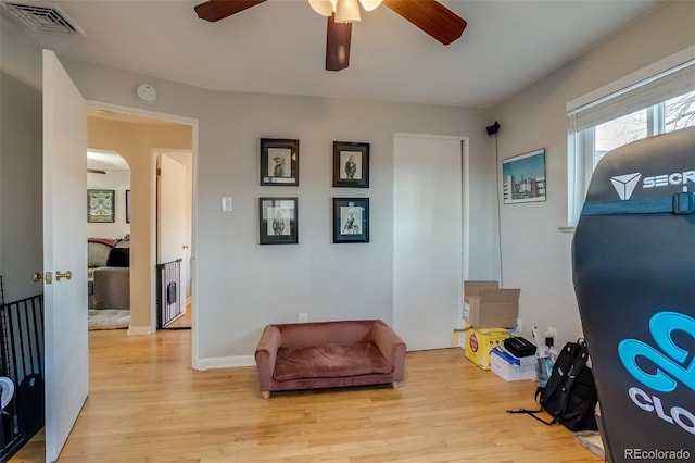 6095 W 47th Ave, Wheat Ridge, CO 80033 - sitting room with ceiling fan, light wood finished floors, arched walkways, and baseboards