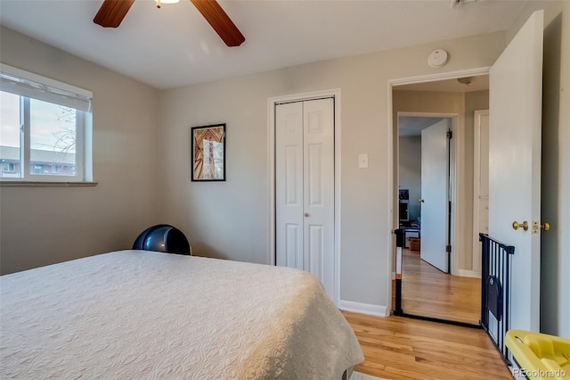 6095 W 47th Ave, Wheat Ridge, CO 80033 - bedroom with light wood-style floors, a closet, a ceiling fan, and baseboards