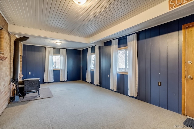 6095 W 47th Ave, Wheat Ridge, CO 80033 - interior space featuring carpet, a wood stove, and healthy amount of natural light