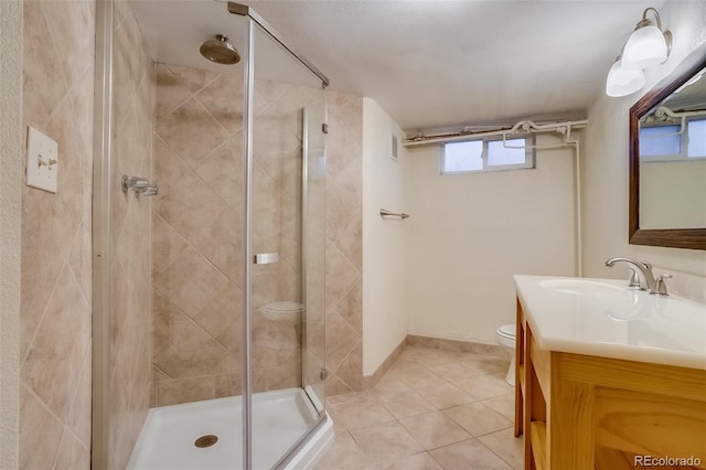 6095 W 47th Ave, Wheat Ridge, CO 80033 - bathroom featuring toilet, a shower stall, tile patterned floors, and vanity
