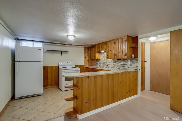6095 W 47th Ave, Wheat Ridge, CO 80033 - kitchen with white appliances, open shelves, light countertops, a peninsula, and a textured ceiling